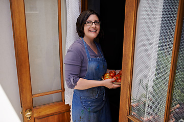 Image showing Portrait, smile and woman with tomatoes in doorway of home for agriculture, farming or sustainability. Farmer, gardening and growth with happy mature person in apartment greenhouse for diet or health