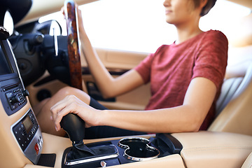 Image showing Closeup, gear and woman in luxury car and driving with steering wheel and travel with transportation. Driver, hands and person with expensive vehicle or road trip with destination and interior design
