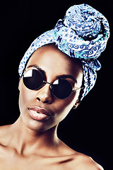 Image showing Portrait, turban and culture with African woman in studio isolated on black background for heritage. Aesthetic, face and shades with confident young model in trendy headwear for traditional style