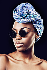 Image showing Face, fashion and culture with African model in studio isolated on black background for heritage. Aesthetic, woman and sunglasses with confident young person in trendy headwear for traditional style