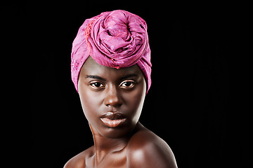 Image showing Black woman, head scarf and beauty portrait with serious, skincare and natural cosmetics in studio. Traditional, turban and African fashion with wellness and skin glow with makeup and dark background