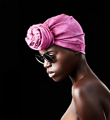 Image showing Profile, fashion and culture with African woman in studio isolated on black background for heritage. Aesthetic, face and sunglasses with confident young model in trendy headwear for traditional style