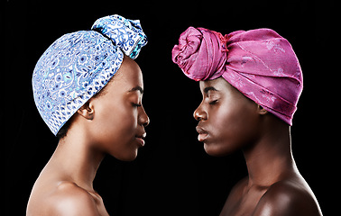 Image showing Studio, sisters and black women with skincare for beauty, profile and head wrap for aesthetic. Dark background, African female people and glow with shine of face, cosmetics and dermatology results