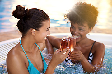 Image showing Women, friends and Champagne in jacuzzi at spa, self care and relax on pamper day for wellness and cold beverage. Water, bubbles and alcohol drink in hot tub for detox and friendship date for bonding