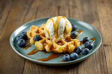 Image showing plate of belgian waffle with caramel sauce and blueberries
