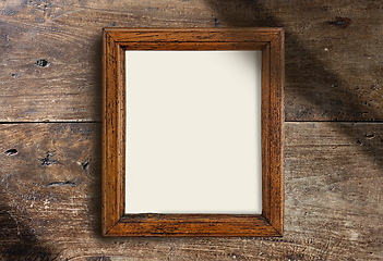 Image showing empty wooden frame on wall