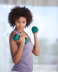 Image showing Woman, workout and dumbbell for fitness, exercise and wellness with power, resilience and strength. Strong, young and African person with training gear, weightlifting and muscle health at her home