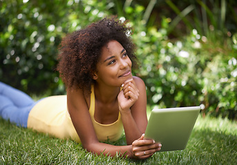 Image showing African woman, tablet and relax on grass with thinking, memory and smile for post on web blog. Girl, digital touchscreen and happy in backyard, garden and outdoor with app for social media in Brazil