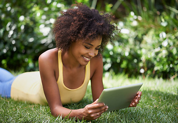 Image showing African woman, tablet and smile on grass with thinking, reading or relax with post on web blog. Girl, digital touchscreen and happy in backyard, garden and outdoor with app for social media in Brazil