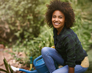 Image showing Woman, gardening and portrait with water can, plants and happy for spring, outdoor and earth. Girl, African person and smile on ground for growth, development and nature with ecology in backyard