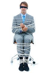 Image showing Businessman, tied up and hostage with chair in kidnapped, robbery or silence on a white studio background. Man or employee with ropes or handcuffs in crime, theft or business corruption on mockup