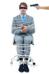 Image showing Businessman, tied up and hostage with gun on chair in kidnapped, robbery or silence on a white studio background. Young man or employee with ropes or handcuffs in crime, theft or corruption on mockup
