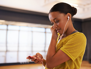 Image showing Sound, music and dancer listening with earphones connect on digital device in studio or gym in weekend. Audio, female person and woman streaming songs on app to relax with technology for girl