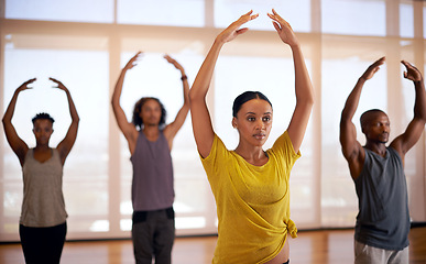 Image showing People, dancing and stretching with team in studio for workout, exercise or indoor training together. Female person, coach or instructor in body warm up or group of dancers in fitness for balance