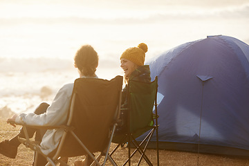 Image showing Happy, camping and couple by tent on vacation, adventure or holiday in nature for travel. Smile, love and young man and woman talking, bonding and relaxing outdoor for weekend trip by seaside.