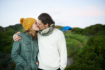 Image showing Date, camping and couple with love, kiss and hug with happiness and vacation for honeymoon. Romance, nature and man with woman and embrace with holiday and bonding together with adventure and smile