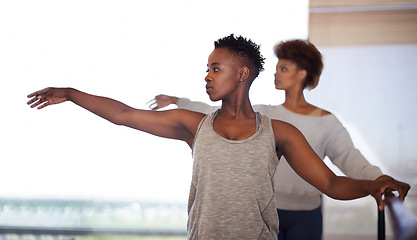 Image showing Woman, dancer and personal trainer with class for ballet lesson, stretching or workout exercise at studio. Young female person or coach training people for dancing, body warm up or healthy practice