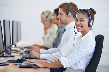 Image showing Callcenter, portrait and phone call with woman, typing on computer and consultant at customer support. Headset, telemarketing and client service agent at help desk with teamwork in coworking space