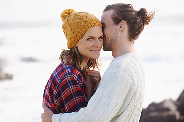 Image showing Love, smile and couple on beach in summer together for holiday, romance or vacation on island coast. Nature, travel or getaway with happy young man and woman hugging by ocean or sea for bonding