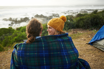 Image showing Blanket, love and couple camping in nature for vacation, adventure or holiday together. Happy, conversation and young man and woman talking, bonding and relaxing by ocean on romantic weekend trip.