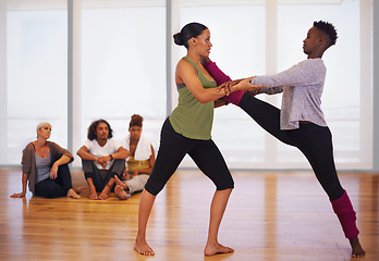 Image showing Stretching, women and dance in gym with partner, personal trainer and African friends together at fitness class. Rhythm, moving and people in studio for practice, performance and flexibility of legs