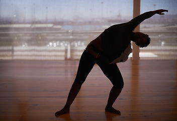 Image showing Person, silhouette and fitness with dancer stretching body for workout or indoor exercise at studio. Performer or ballet in practice, training or balance for graceful dancing, health and wellness