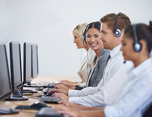 Image showing Help desk, phone call and portrait of woman in row typing on computer at customer support. Headset, telemarketing and client service agent at callcenter for consultation, teamwork and smile in office