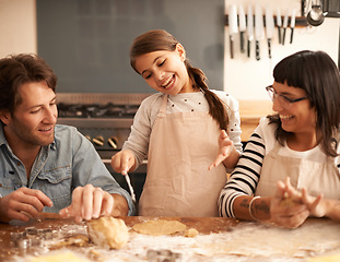 Image showing Mother, father and child with baking dough in kitchen with flour, happiness and teaching with support. Family, parents and girl with helping, learning and bonding with cooking for hobby and playing