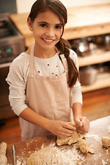 Image showing Girl, dough and baking portrait in kitchen, pastry and prepare flour mixture for cooking. Female person, kid and smile for learning in home, child development and education for cookie skill or cake