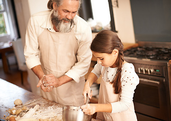 Image showing Girl, child and grandfather with baking in kitchen for cooking, cookies and teaching with support and helping. Family, senior man and grandchild with mixing bowl and preparation in home with learning