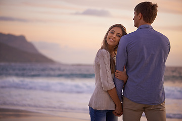 Image showing Couple, holding hands and portrait in embrace by water, ocean and peace for romance in relationship. People, love and security in marriage, sea and travel together on vacation or holiday for date