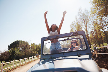 Image showing Happy women, excited and travel on road trip in countryside and bonding together for adventure in nature. Friends, driving and journey in convertible suv on holiday and outdoor in summer in texas