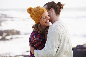 Image showing Hug, beach and couple with love, date and happiness with weekend break, humor and vacation for honeymoon. Outdoor, romance or embrace with woman or man with sunshine or marriage with holiday or funny