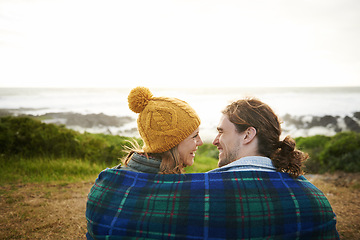 Image showing Happy couple, talking or bonding together in nature, blanket or romantic getaway with camping by ocean. Man, woman or love on vacation on weekend break, cape town or travel adventure by sea in sunset