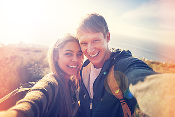 Image showing Hiking, selfie and couple hug in nature with love, trust and bonding outdoor together. Backpack, travel or people portrait in countryside for adventure, vacation or romantic profile picture at sunset