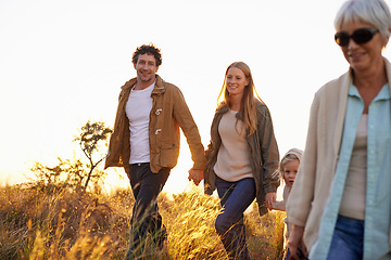 Image showing Morning, walking and nature with family, sunshine and countryside with field and fresh air. Group, mother and father with granny and child with hiking and summer with vacation, happy and getaway trip