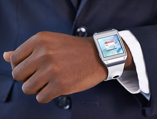 Image showing Businessman, hand and smart watch on wrist for digital agenda, online schedule and high tech for job. Black man, arm and suit with future technology for network, screen and check time at work