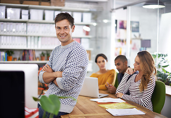 Image showing Designer, portrait and man in meeting with arms crossed for confidence, pride and happiness for startup company. Entrepreneur, employee or face with smile in coworking office for teamwork or planning