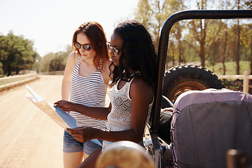 Image showing Women, reading and map on roadtrip in nature, direction and travel adventure with care in outdoor. Friends, lost or navigation with van on summer holiday, rest or bonding together for trip in texas