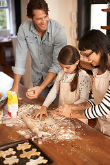 Image showing Parents, kid and happy with bake biscuits in kitchen for easter season or bonding, child development and growth. Home, family and flower or dough for cookies with fun, teaching and support on holiday