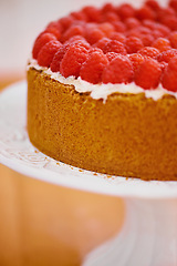 Image showing Plate, cream and cheesecake with raspberries on table for sweet snack for tea time at home. Bakery, catering and closeup of gourmet dessert with crust, frosting and fresh organic fruit in dining room