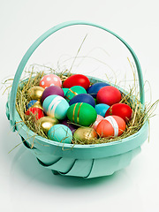 Image showing Easter, basket and eggs for chocolate holiday with dessert snacks for traditional present, festive season or white background. Decoration, mockup space and studio with shell pattern, nest or giving