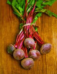 Image showing Beetroot, closeup and counter for health, wellness or organic diet on wood countertop. Vegetable, nutrition or produce for eating, gourmet and meal or cuisine with minerals or fibre for weight loss