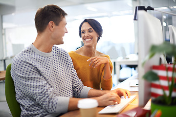 Image showing Computer, discussion and businessman with woman in office of startup company with creative career. Conversation, technology and team of graphic designers working on project with desktop in workplace.