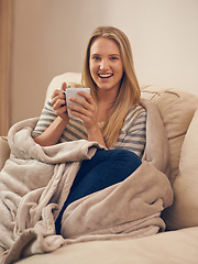 Image showing Happy, portrait and woman on a sofa with coffee break, relax or chilling on weekend in her home. Face, smile and female person in a living room with tea cup for resting, peaceful or me time in house