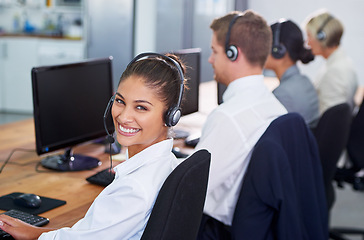 Image showing Help desk, phone call and row with portrait of happy woman at customer support office with headset. Smile, telecom and client service agent at callcenter for online consultation, team and computer