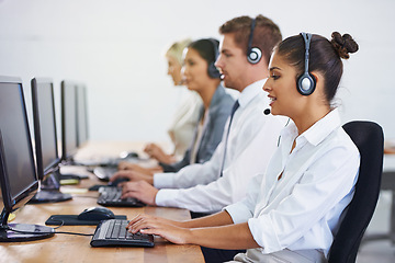 Image showing Help desk, team and phone call with women, men and typing on computer at customer support. Headset, telemarketing and client service agent at callcenter with online consultation in coworking space