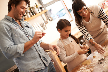 Image showing Mother, father and girl with baking dough in kitchen with flour, happiness and teaching with support. Family, parents and child with helping, learning and bonding with cooking for hobby and snack