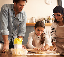 Image showing Mother, father and girl with dough for cooking in kitchen with rolling pin, happy and teaching with support. Family, parents and child with helping, learning and bonding with flour for cake and snack