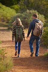 Image showing Path, hiking and happy couple walking in nature for holiday, travel or adventure outdoor with backpack. Rear view, man and woman trekking in the countryside on vacation, journey and date together